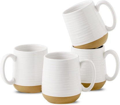 White ceramic coffee mugs with comfortable handles and a gold band around the base