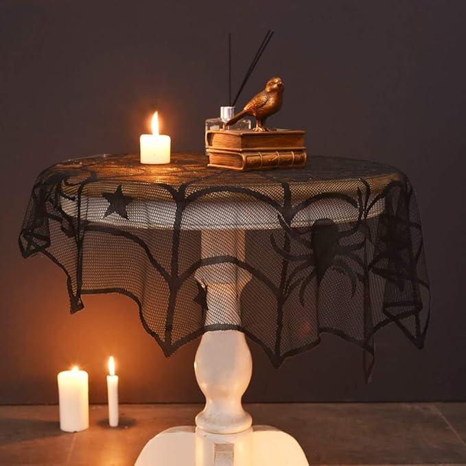 Black spider web mesh table cover with star and spider accents, draped style