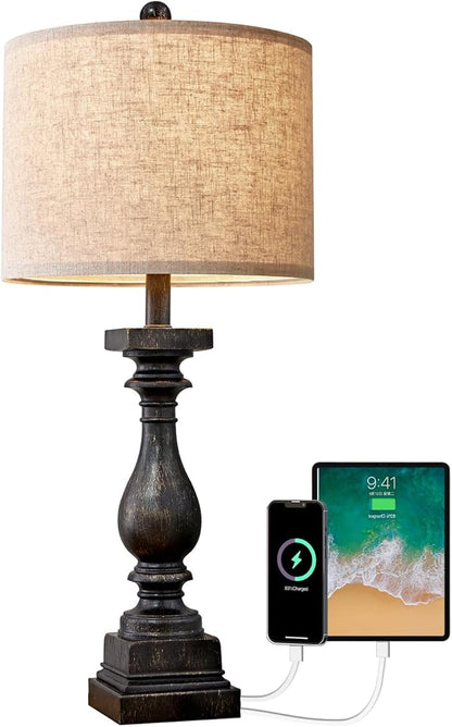 Table lamp close-up with fabric shade, dark resin base, and USB charging ports