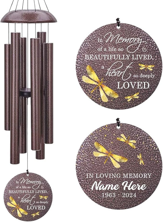 Bronze-tone dragonfly wind chime with speckled tubes and round "In Loving Memory" medallion.