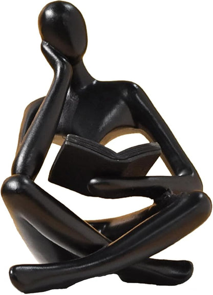 Zuo Si black resin reading thinker figurine, seated with crossed legs and book