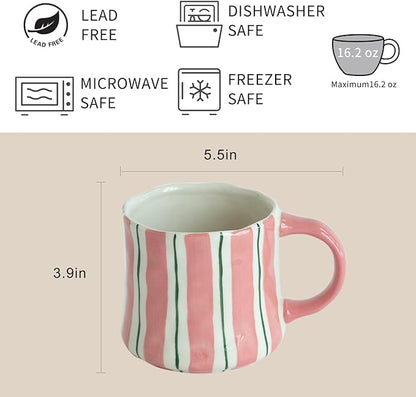 Striped ceramic coffee mug with pink handle and vertical green lines, side view