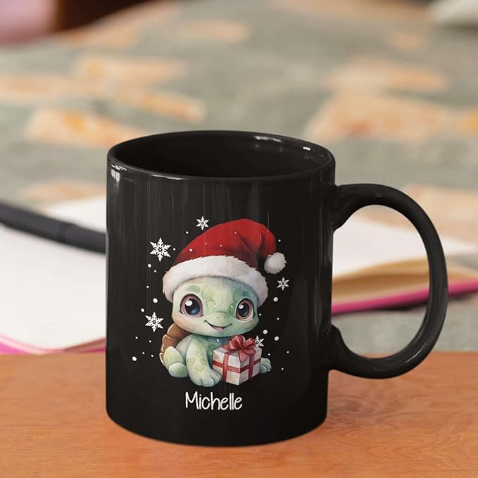 Black ceramic mug with turtle in Santa hat holding gift, name Michelle, angled view