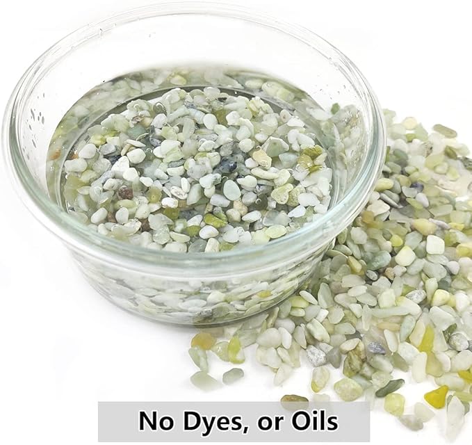 Glass jar filled with polished jade-green and white decorative stone pebbles