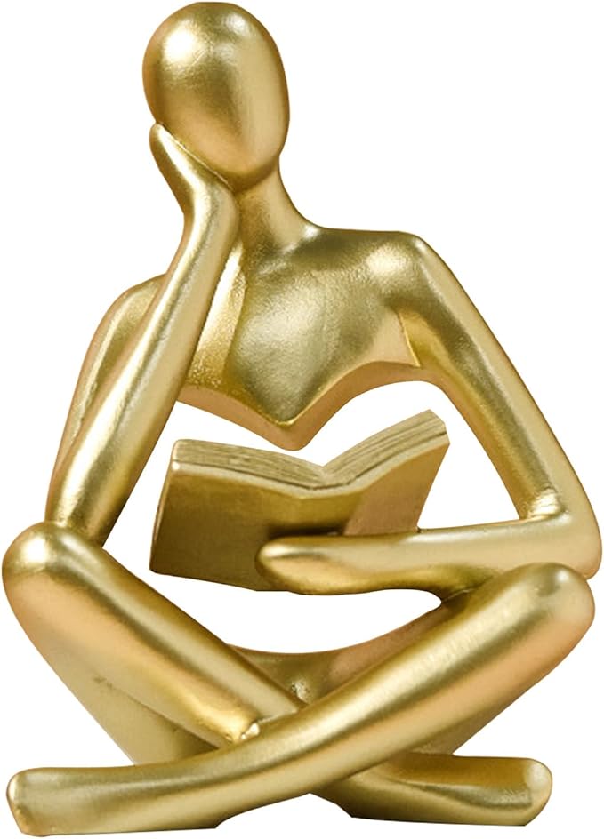 Gold resin seated thinker figurine reading an open book