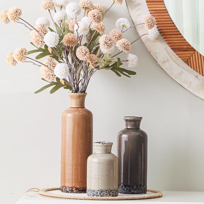 Set of three rustic ceramic vases: tall terracotta, cream, and dark gray with speckled bases