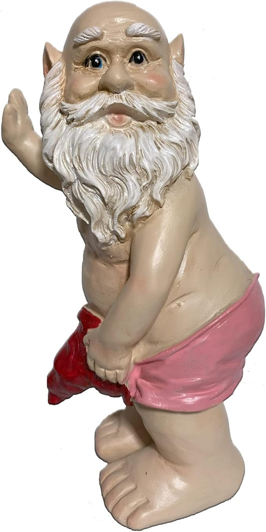 Garden gnome statue kneeling, white beard, pink shorts, waving hand