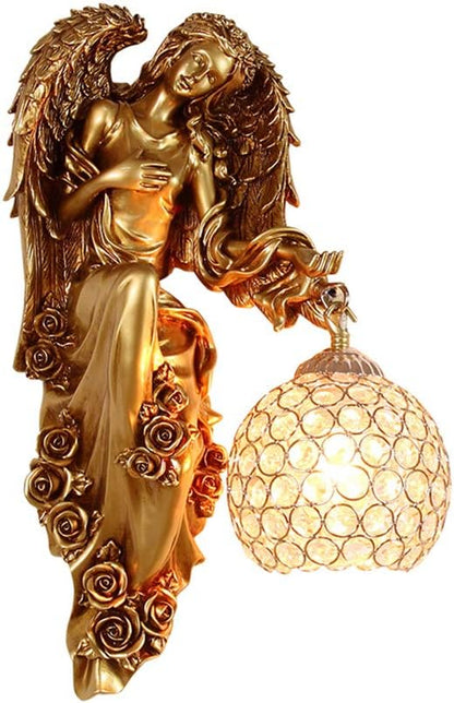 Gold angel wall sconce with ornate wings and clear crystal globe shade