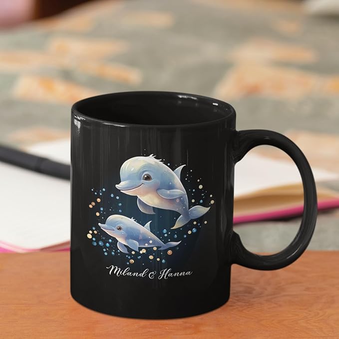 Black coffee mug with blue dolphin pair graphic and custom name, side view