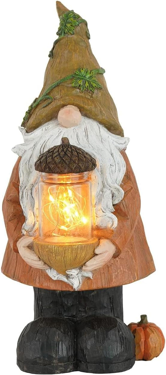 Autumn garden gnome statue holding a lit lantern with pine cone topper