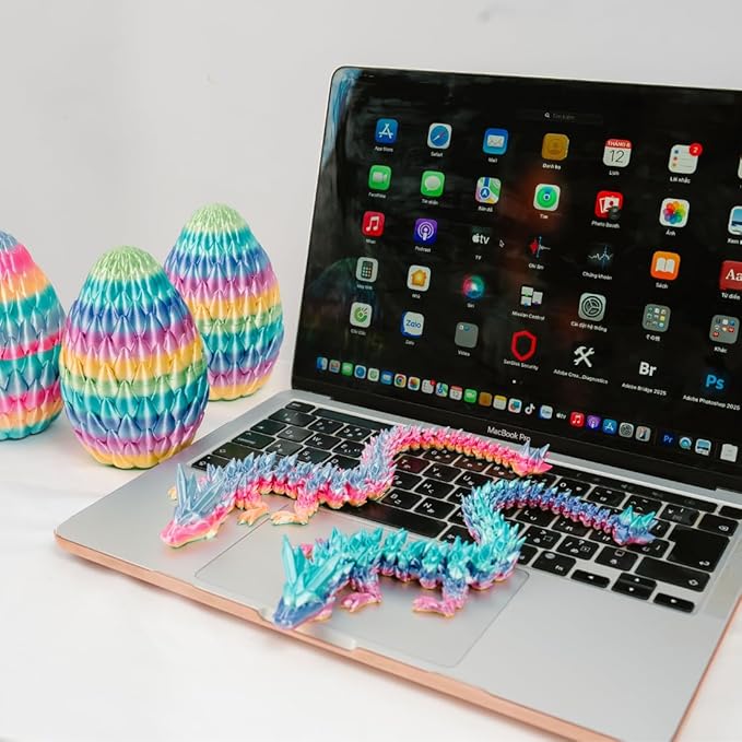 Rainbow 3D printed eggs and articulated crystal dragon fidget, arranged on desk