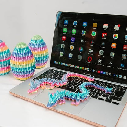 Rainbow 3D printed eggs and articulated crystal dragon fidget, arranged on desk