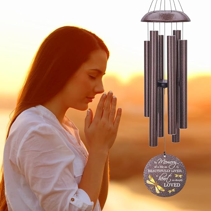 Bronze-tone dragonfly wind chime with hanging tubes and round medallion reading "Beautifully Loved".