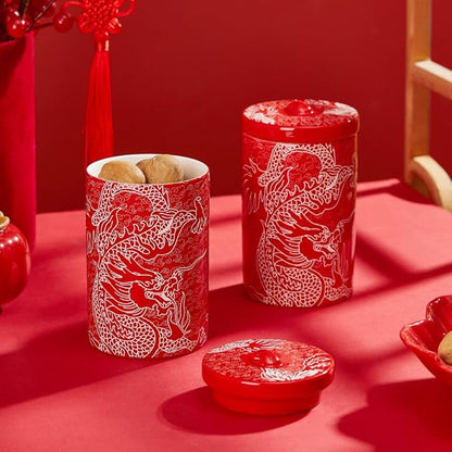 Set of red porcelain canisters with white dragon designs and matching lids