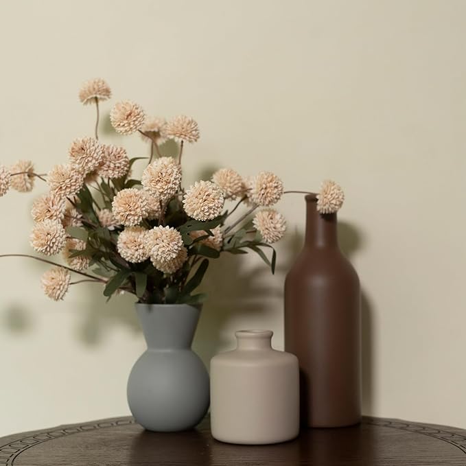 Ceramic vase set with faux chrysanthemum stems and three matte brown/cream/gray vases