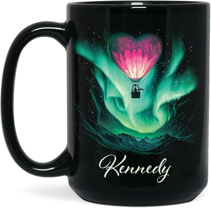 Black ceramic coffee mug with green aurora hot air balloon heart design and name Kennedy