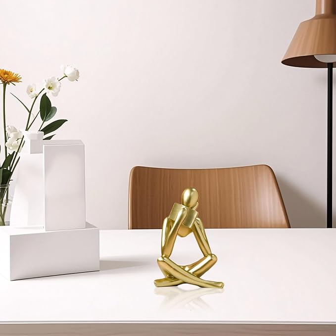Gold reading thinker resin statue, seated bookend with bowed head and crossed legs.