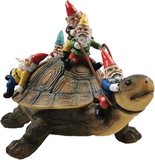 Resin turtle yard ornament with gnomes sitting on its shell, colorful hats and robes