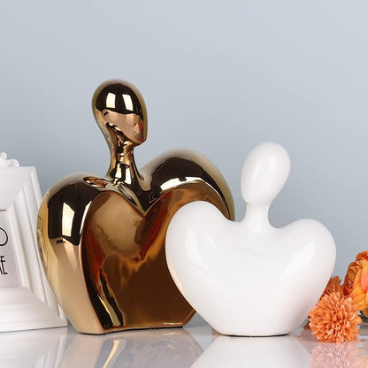 White and gold ceramic hugging couple figurine with glossy gold heart and white body