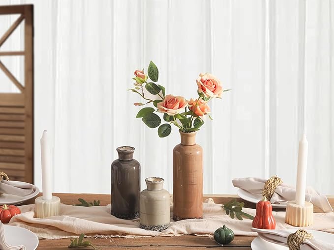 Set of three ceramic vases with a bouquet: tall terracotta, dark gray, and cream