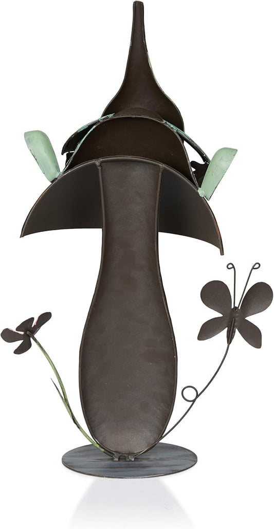 Metal gnome garden statue with dark brown mushroom cap, green wing ornaments, white beard, round base