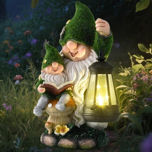 Flocked parent and child reading gnome statue with glowing solar lantern