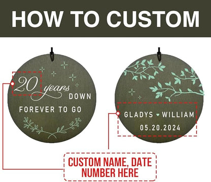 Personalized anniversary wind chime disc in dark green reading 20 years down
