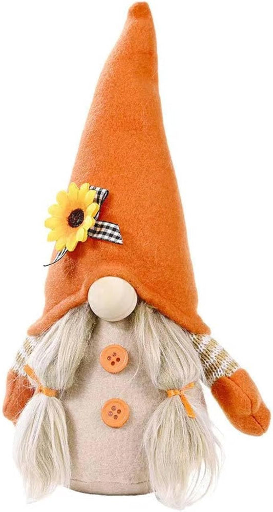 Orange plush gnome doll with white beard, flower patch, and buttoned vest.