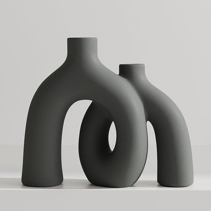 Dark gray matte ceramic vase sculpture with oval donut cutout