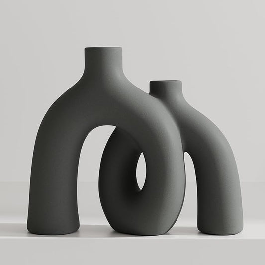 Dark gray matte ceramic vase sculpture with oval donut cutout