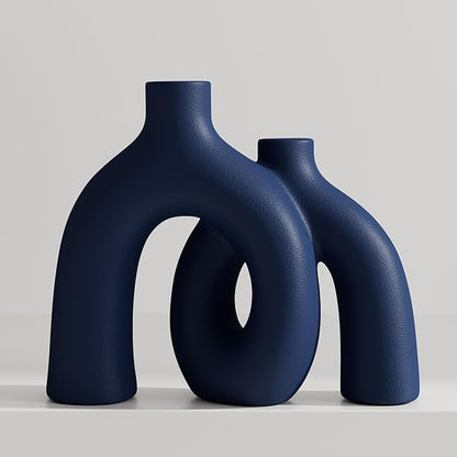 Matte navy ceramic hug vase with conjoined donut shapes, standing upright.