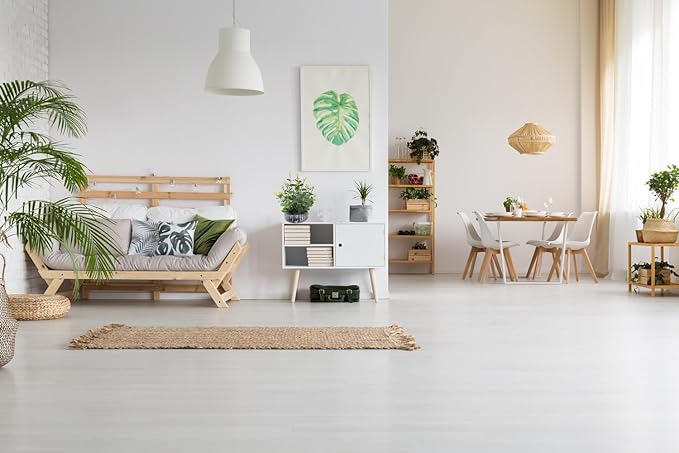 Faux eucalyptus plant in a dark ribbed pot on the living room floor