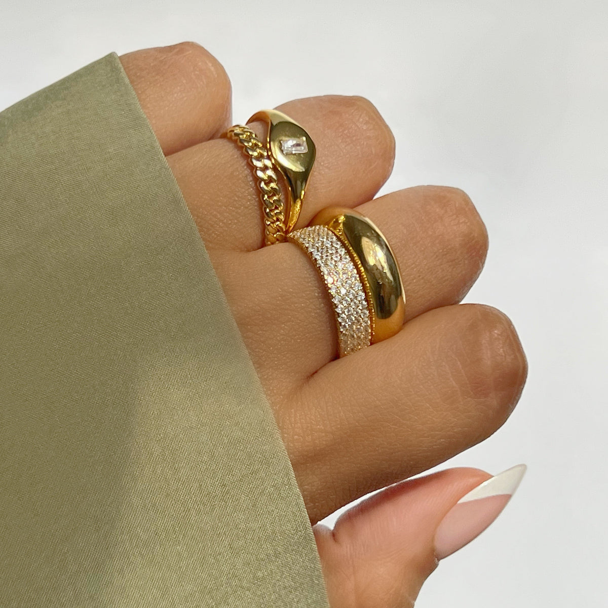 Gold-tone rounded signet-style ring with smooth domed top