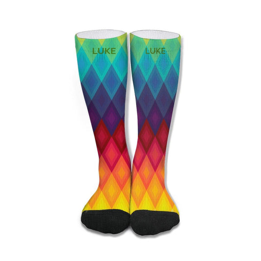Mid-calf socks with colorful diamond rainbow pattern and black toes; 'LUKE' on the cuff.