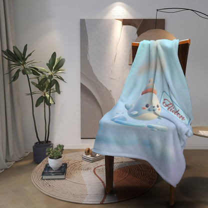 Light blue plush blanket with seal character, “Aiden” logo, and scalloped edge