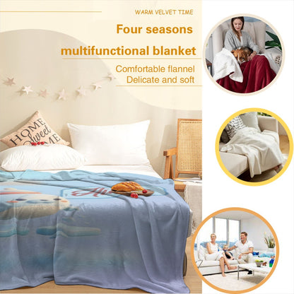Light blue plush blanket spread on a bed with seal character print