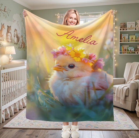 Personalized kids blanket featuring a fluffy bird with a flower crown and red name text