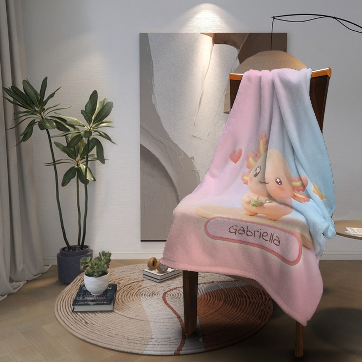 Pink and light-blue character blanket with bear holding drink and “Gabriella” graphic