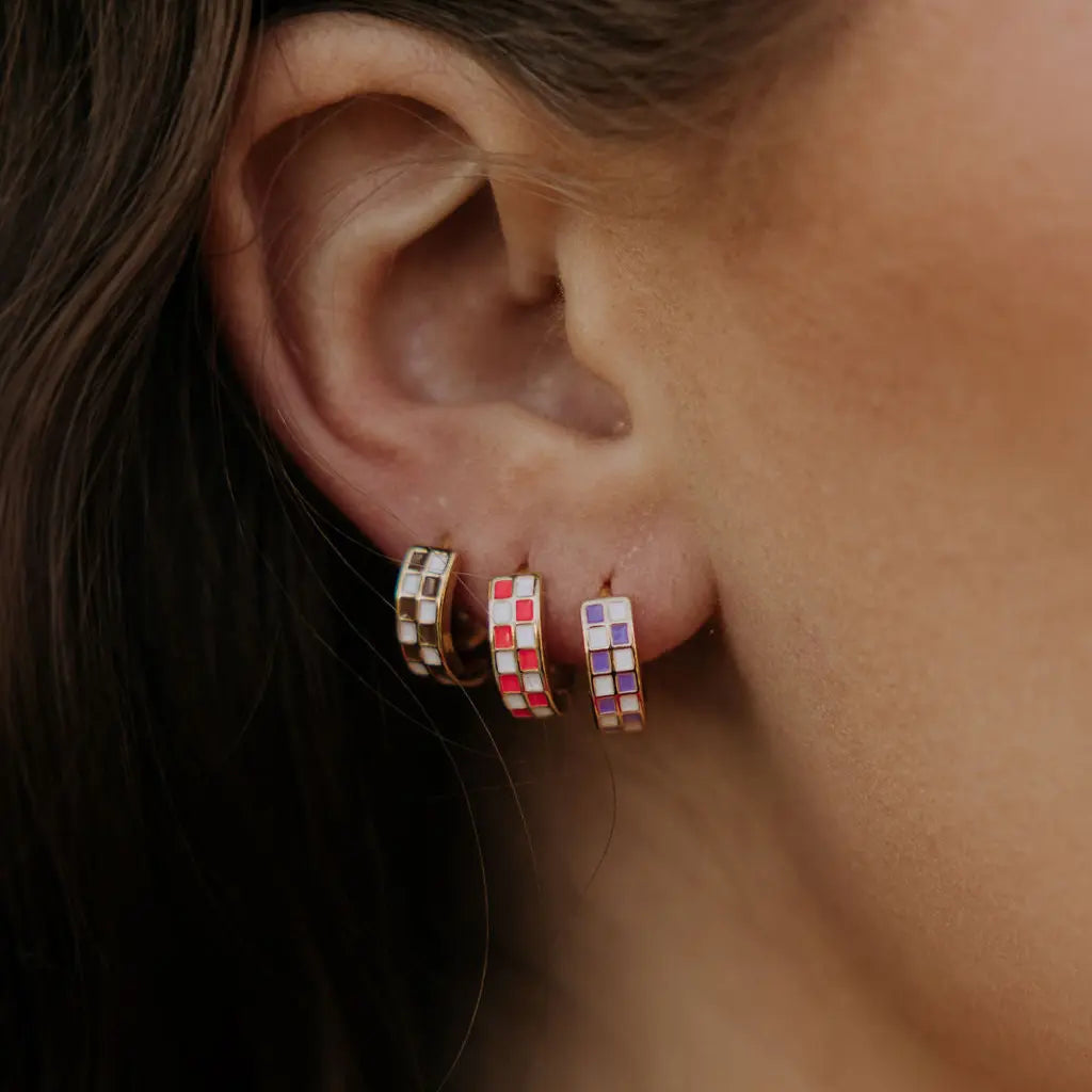 Three gold-filled huggie hoops with cream, red, and purple checkered inlays