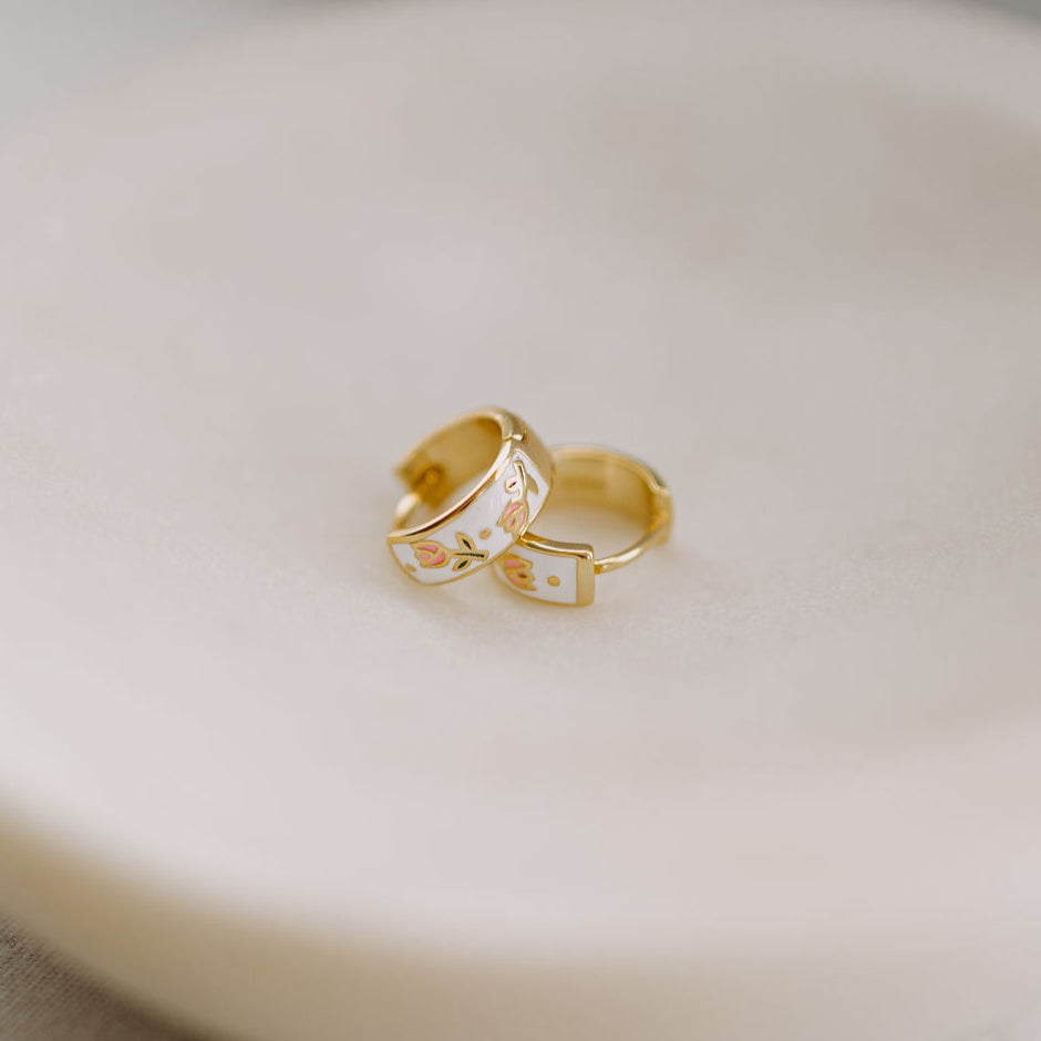 Gold enamel huggie hoop earrings with floral tea cup motifs
