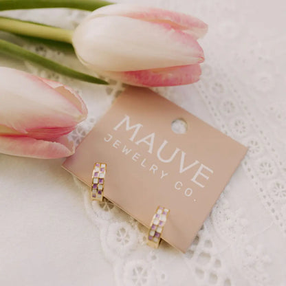 Pastel checkered gold-filled huggie hoops displayed on a jewelry card