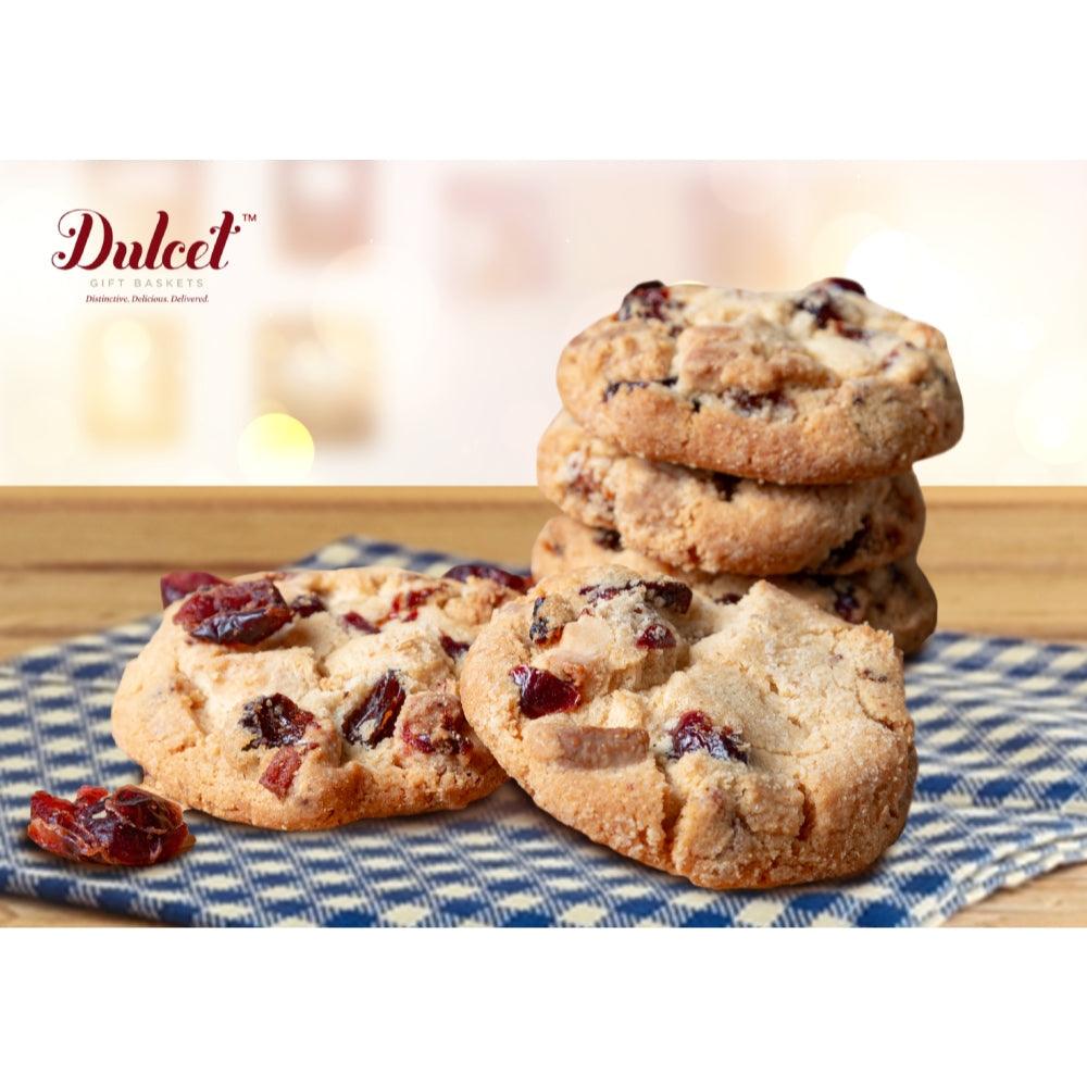 Assorted baked cookies with fruit bits, stacked on a plate