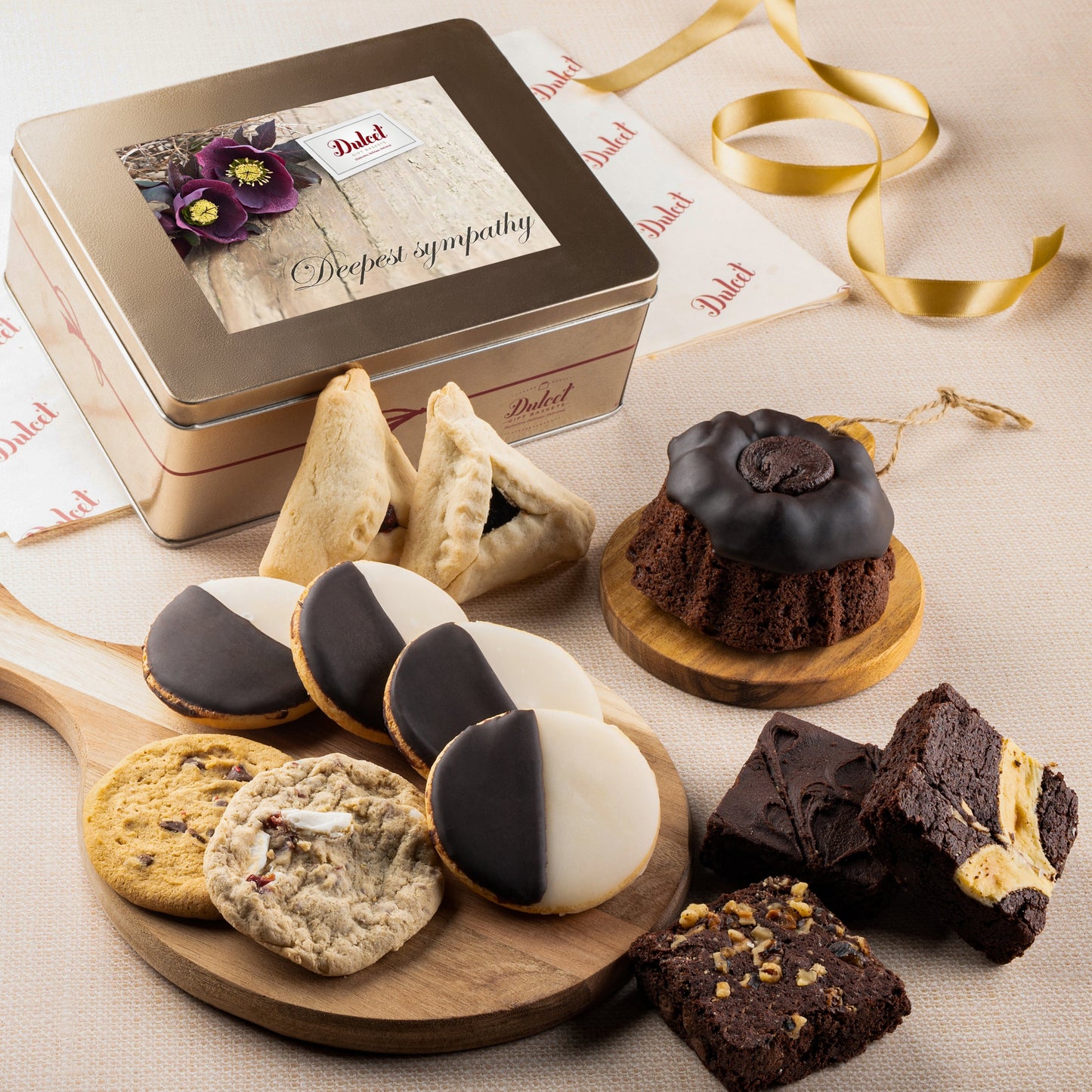 Cookie and brownie keepsake gift tin with sympathy card and assorted cookies on boards