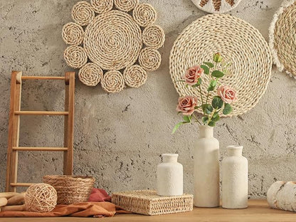 Set of 3 white ceramic vases with textured finish, displayed on a tabletop