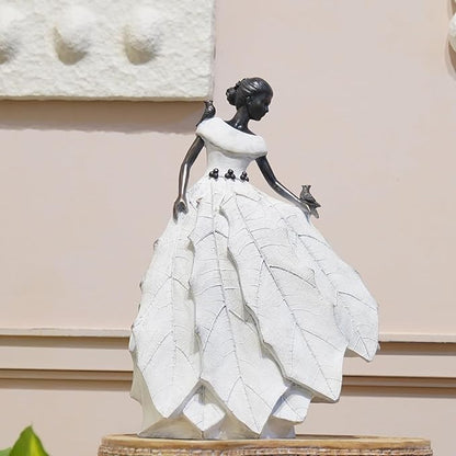 White resin fairy maiden statue standing on base with layered skirt and bird figure