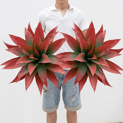 Faux agave plants with red and green spiky leaves, shown in gold planters