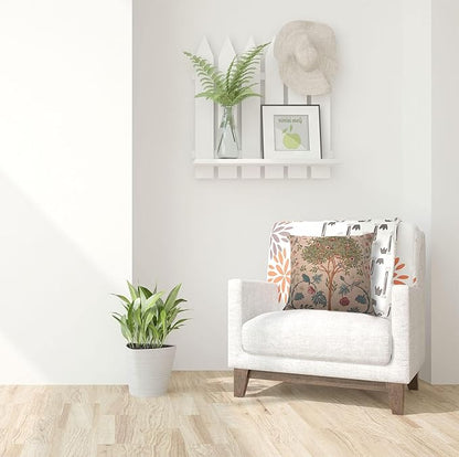 Beige square pillow cover with tree-and-bird tapestry design on an armchair
