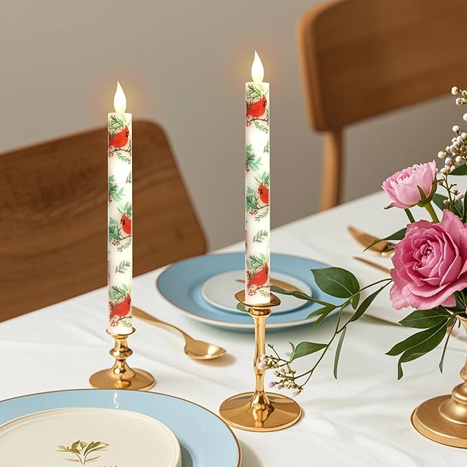 LED taper candles, white with red cardinal and green leaf print, mounted in gold bases.