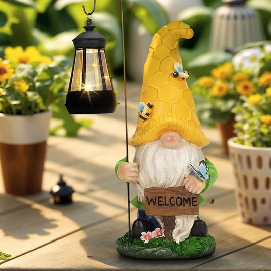 Yellow hood garden gnome statue holding a black solar lantern, welcome sign