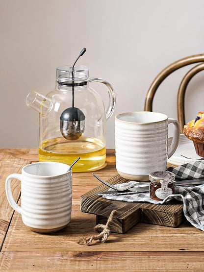 Arctic white ribbed ceramic mugs with handles on a wooden table